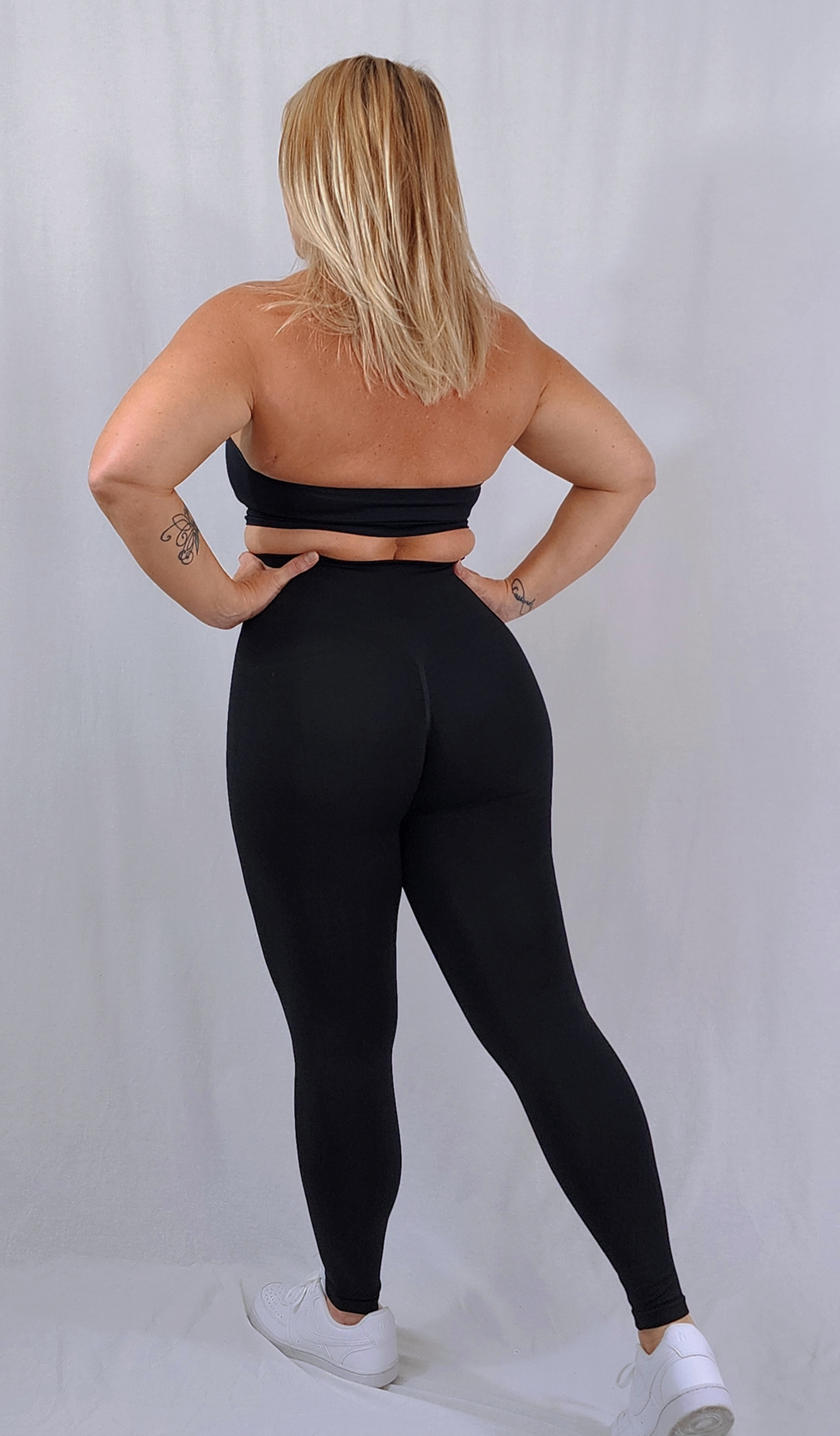 Gym Brand Apparel black leggings and black halter sports bra back view.