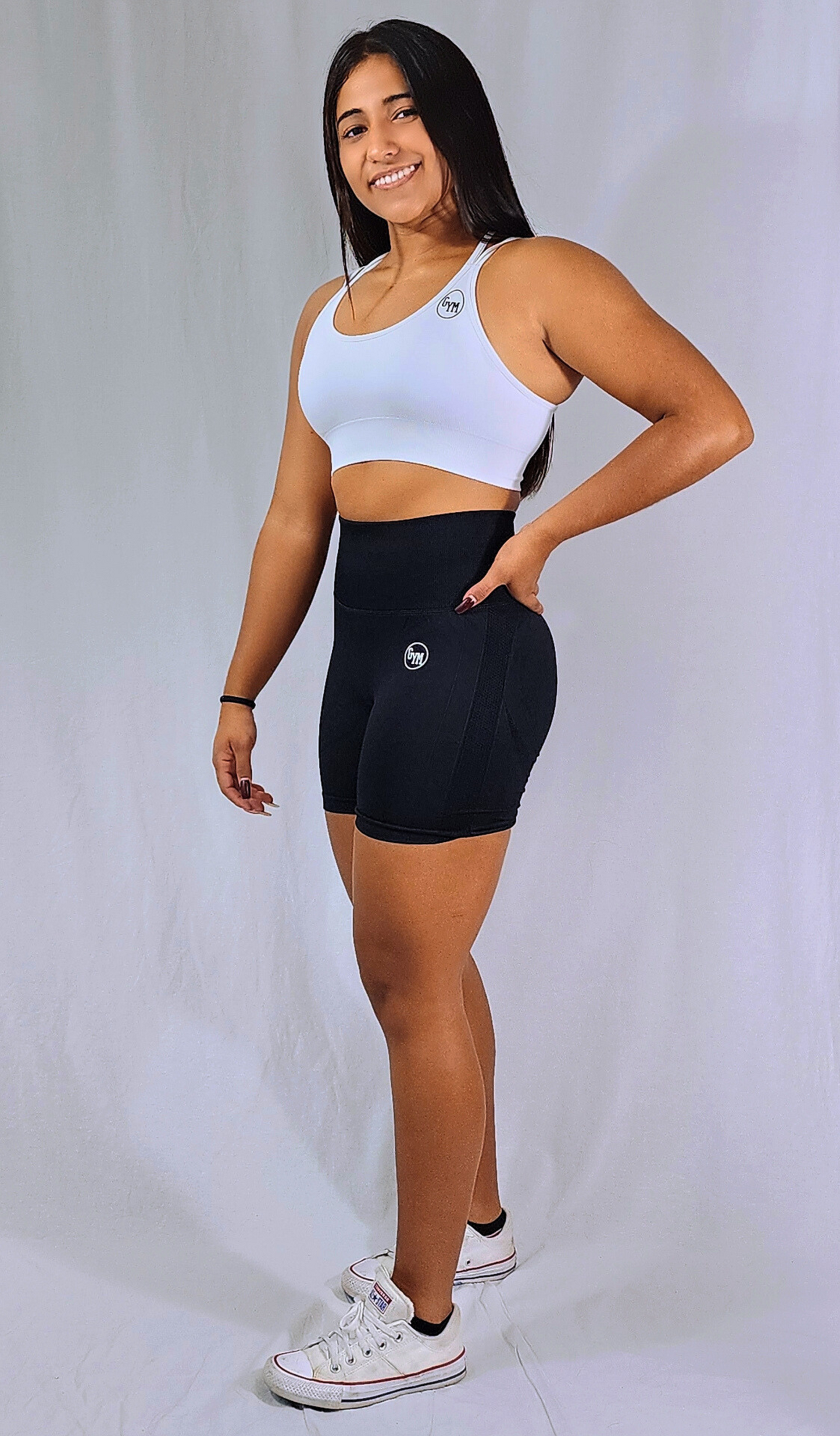 Gym Brand Apparel black shorts and white strap back sports bra side view.