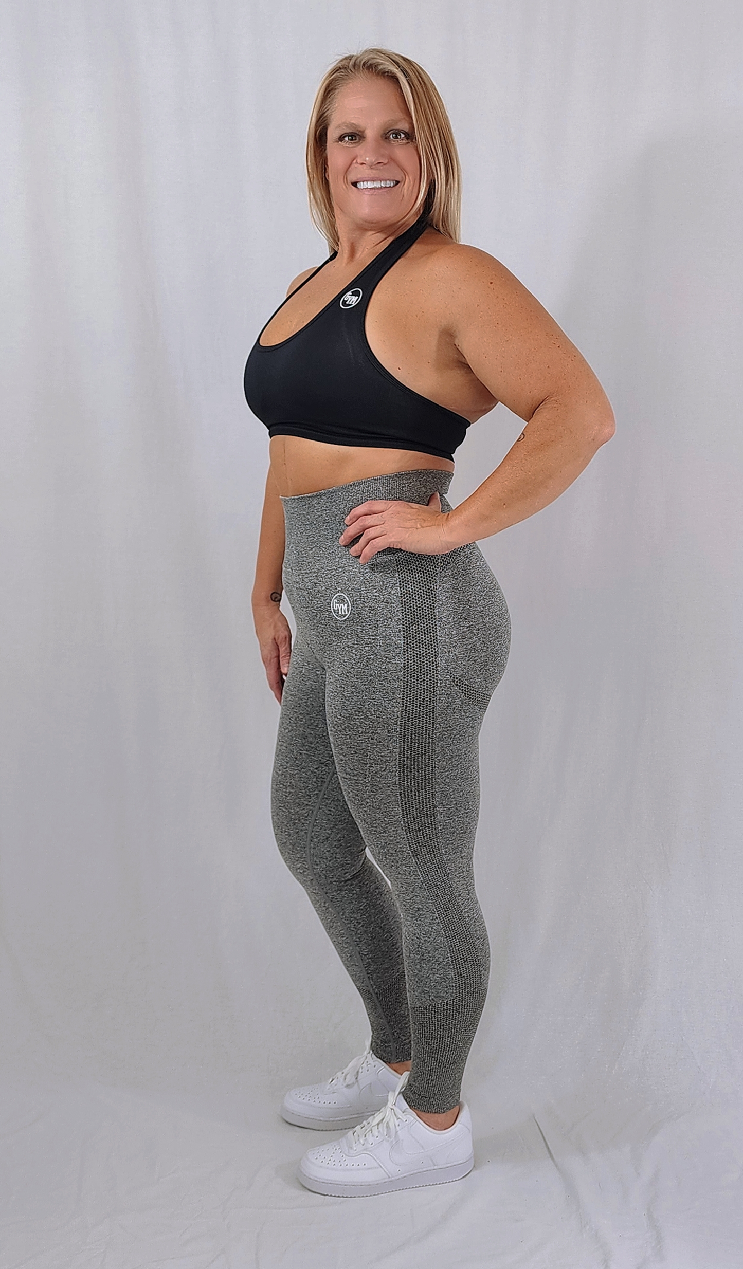 Gym Brand Apparel grey leggings and black halter sports bra side view.