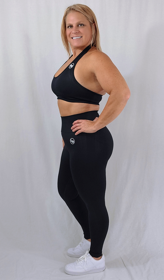 Gym Brand Apparel black leggings and black halter sports bra side view.