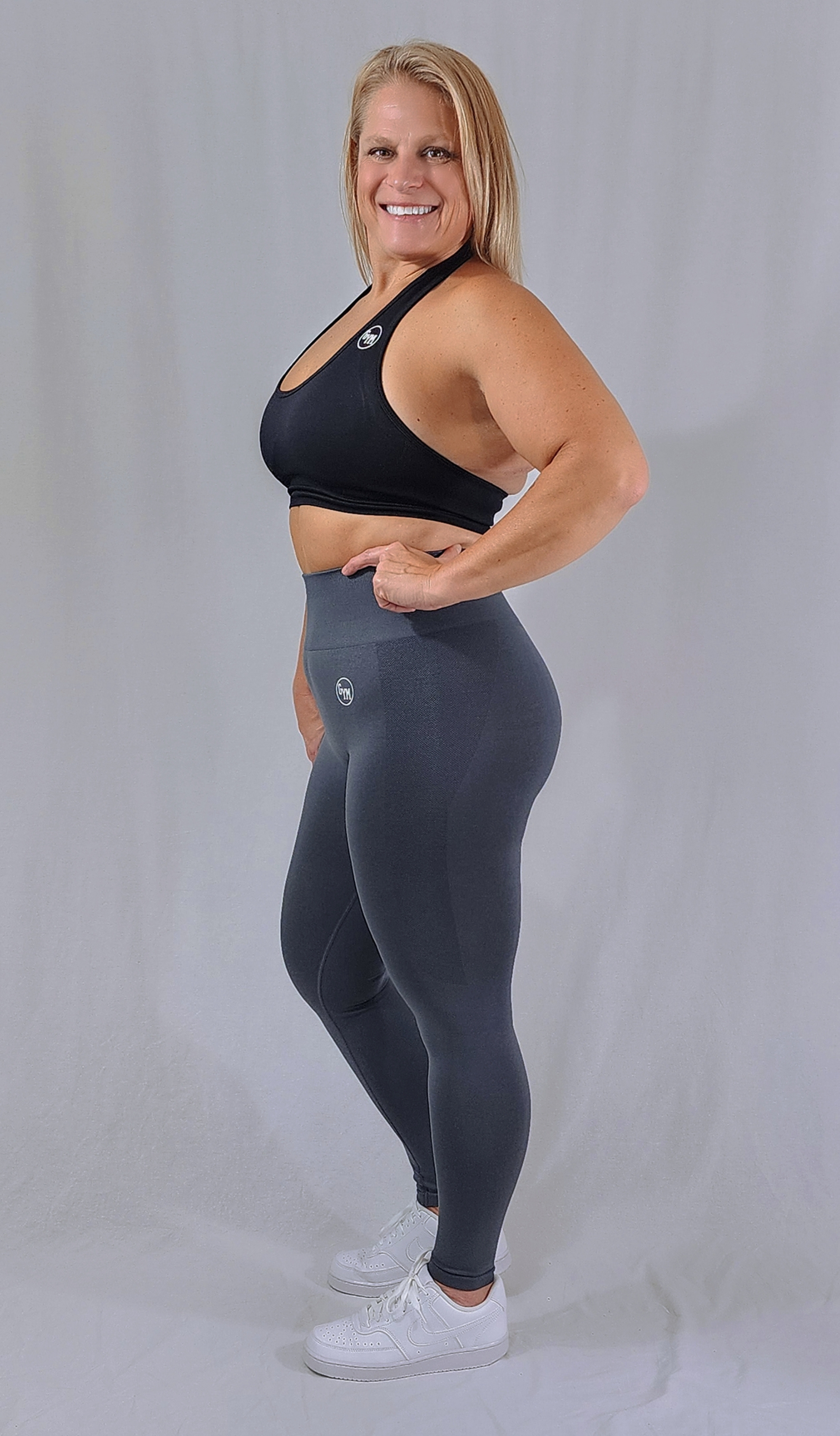 Gym Brand Apparel dark grey leggings and black halter sports bra side view.