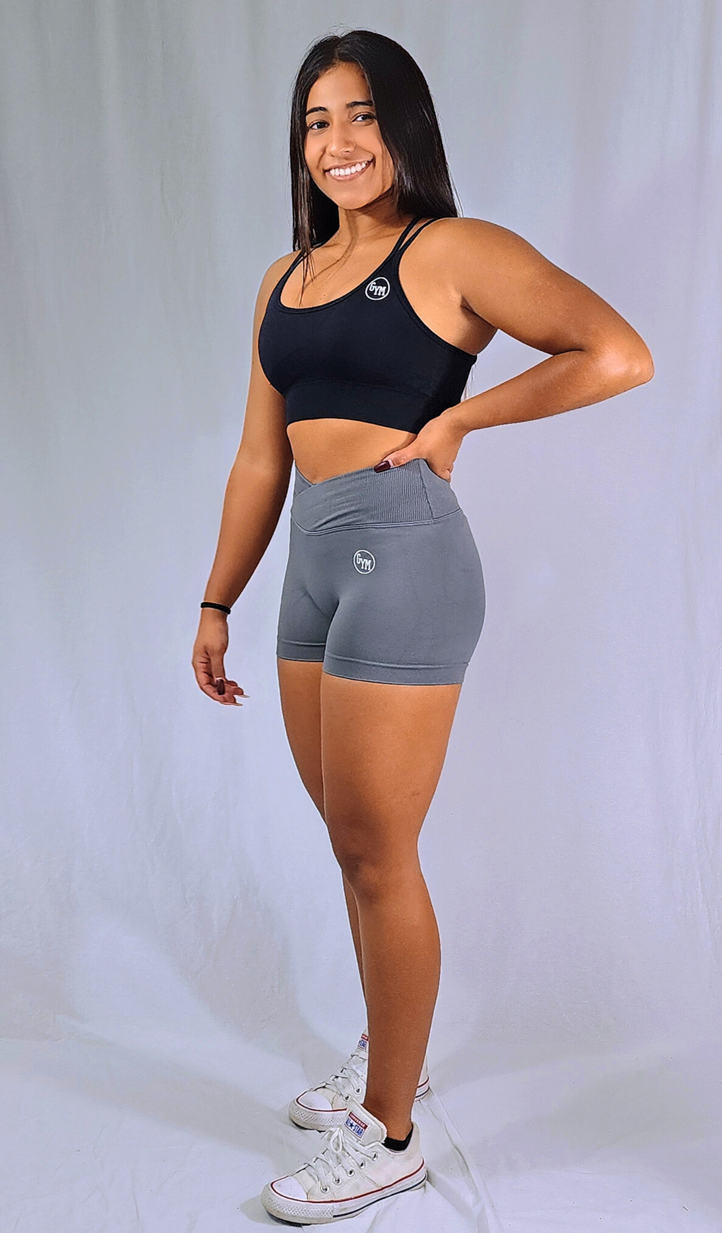 Gym Brand Apparel grey shorts and black strap back sports bra side view.